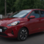 Red Hyundai i10 parked outdoors, side view