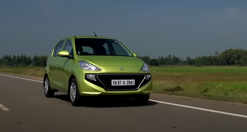 Green Hyundai Santro side view on the road