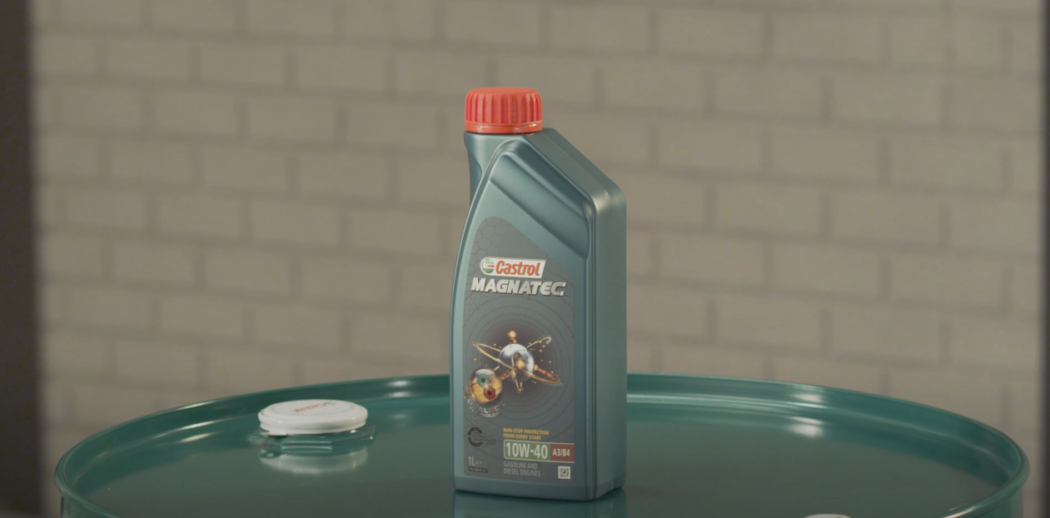 Bottle of 10W-40 Motor Oil resting on top of a drum