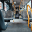 empty bus with brown and black seats with yellow grab handles