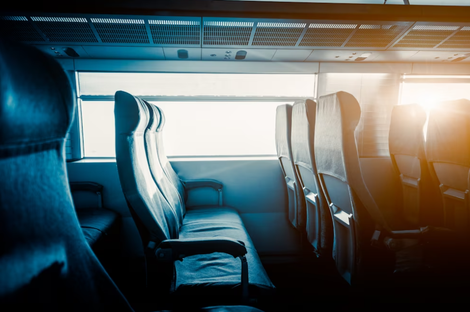 side view of bus seats and the sunset in the window