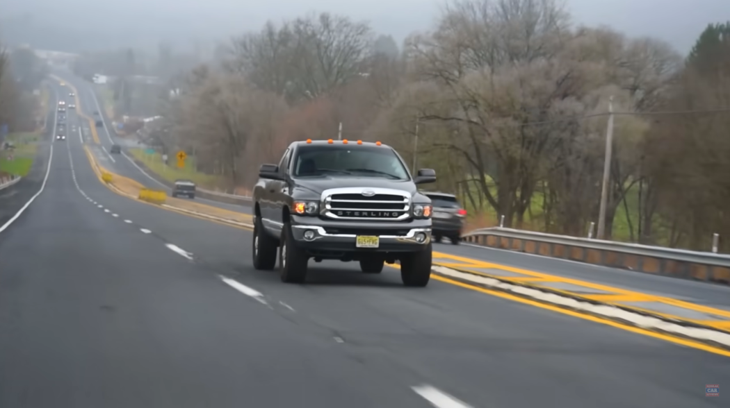 Dodge Ram 2500 Cummins 6MT on the road among other cars, trees near the road