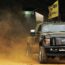 Big black truck in the dust
